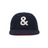 Navy blue cap with a white ampersand symbol on a white background