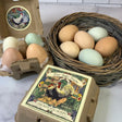 Eggs in a carton and basket with a box of  chicken egg soaps on a marble surface.