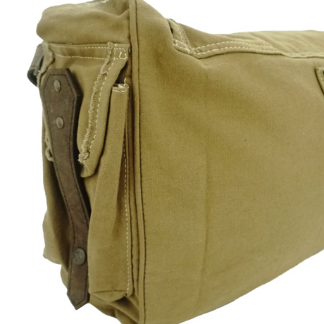 Close-up of a brown leather bag with visible stitching on a white background