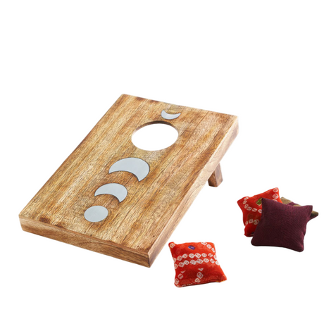Wooden cornhole board with three bags on a white background
