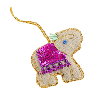 Decorative elephant ornament with pink sequin heart and gold trim on a white background