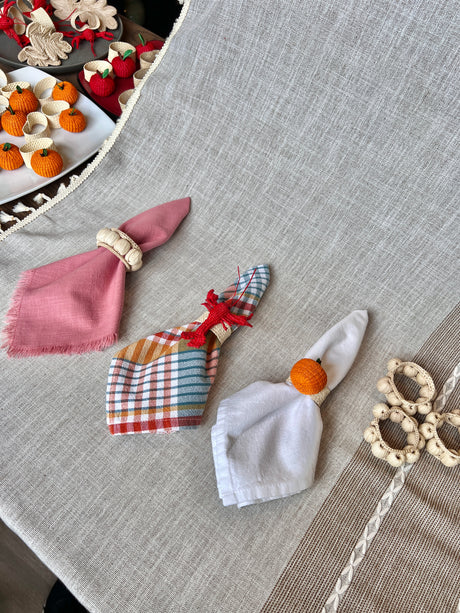 Decorative napkin rings on a textured surface with a blurred background