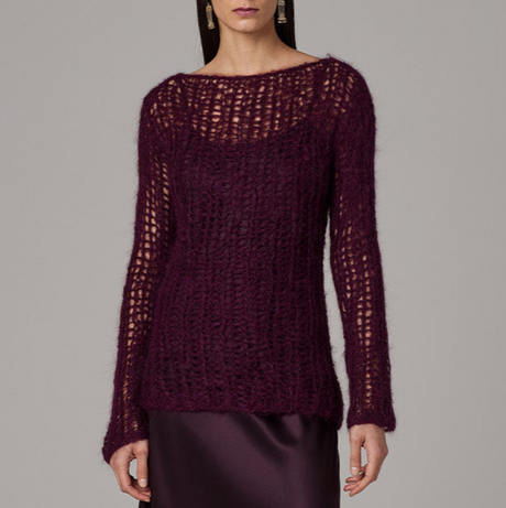 Maroon knitted sweater worn by a model on a gray background