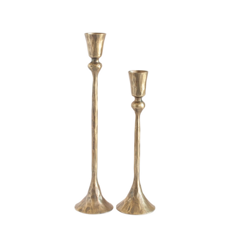 Two gold candle holders on a white background