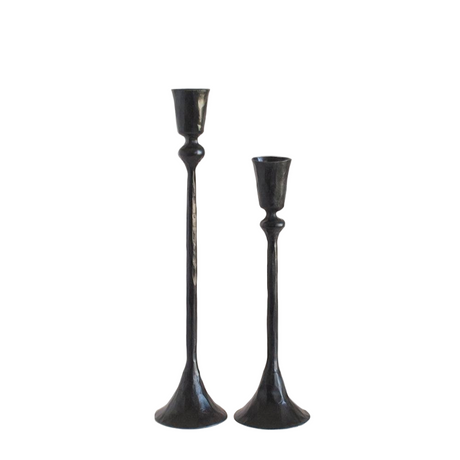Two black candle holders on a white background