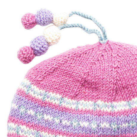 Pink knitted hat with colorful pom-poms on a white background