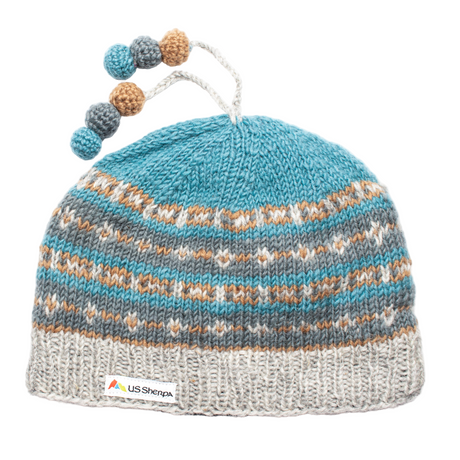 Knitted baby hat with colorful pom-poms on a white background