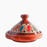 Ceramic tagine with colorful patterns on a white background