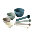 Set of colorful bowls and measuring cups on a white background