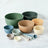 Set of colorful bowls and measuring cups on a light surface