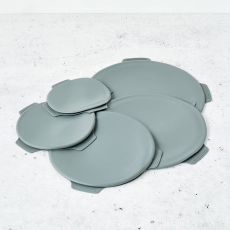 Set of gray silicone coasters on a white surface