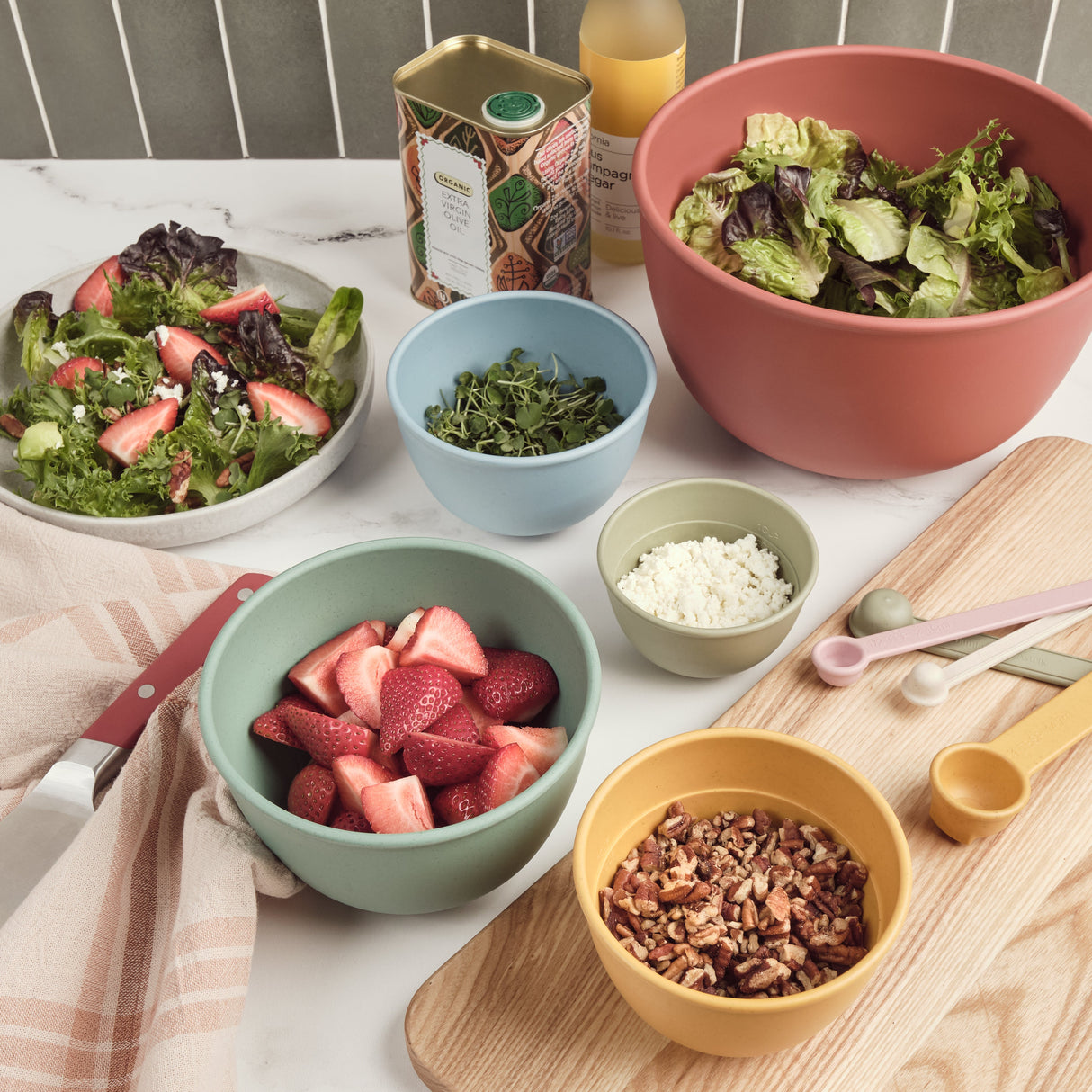Assorted bowls with salad ingredients on a table