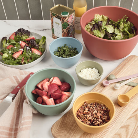 Assorted bowls with salad ingredients on a table