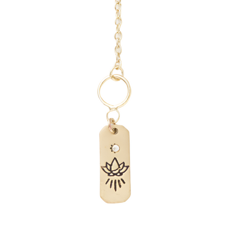 Gold necklace with a tag featuring a lotus flower design on a white background