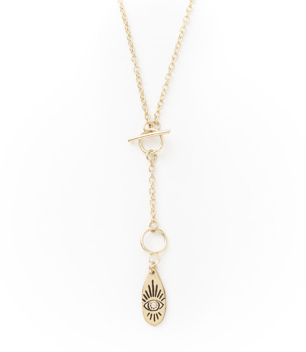 Gold necklace with a teardrop-shaped pendant on a white background