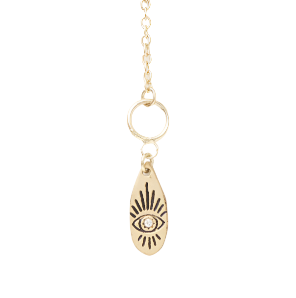 Gold necklace with an eye-shaped pendant on a white background