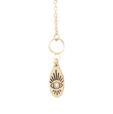Gold necklace with an eye-shaped pendant on a white background
