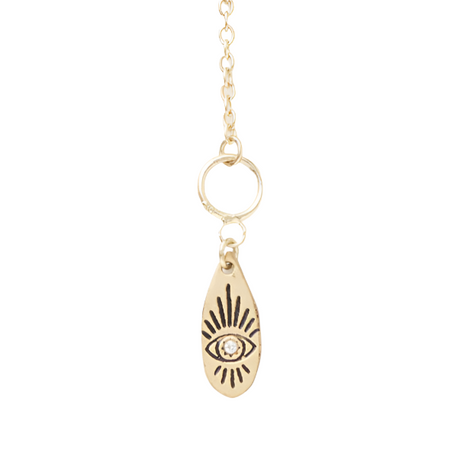 Gold necklace with an eye-shaped pendant on a white background