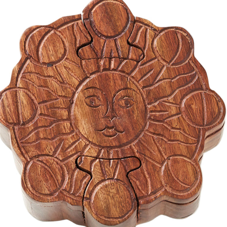 Wooden puzzle jewelry box with sun design on a white background