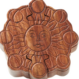 Wooden puzzle jewelry box with sun design on a white background