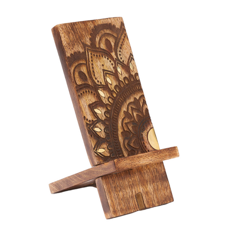 Wooden phone stand with intricate carvings on a white background