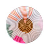 Round woven basket with concentric circle pattern on a white background
