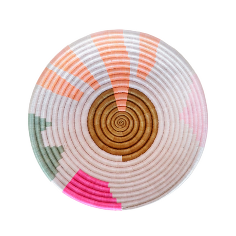 Round woven basket with concentric circle pattern on a white background