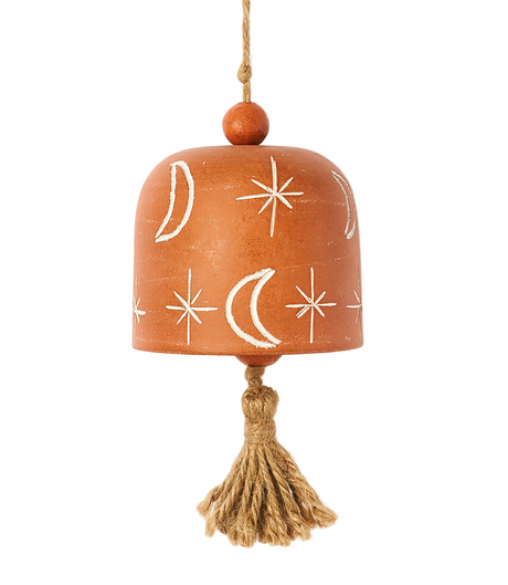 Decorative terracotta bell with star and moon patterns on a white background