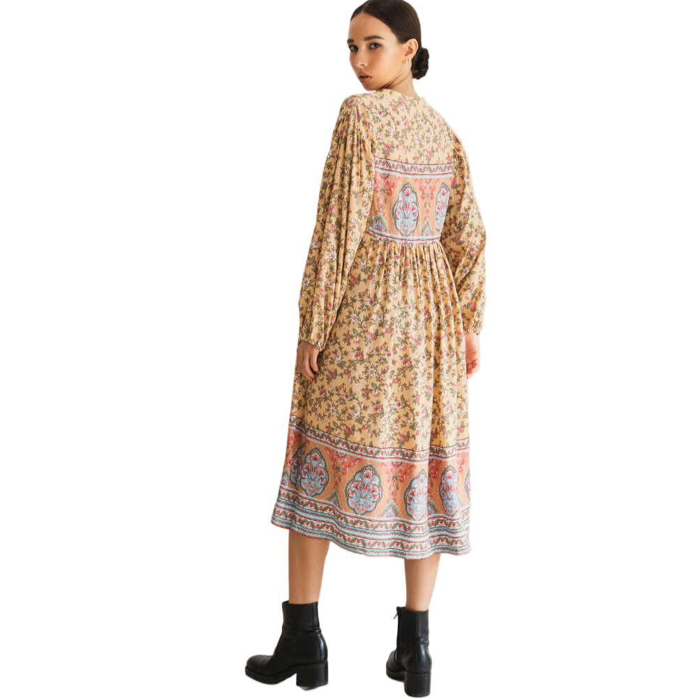 Woman wearing a patterned dress on a white background