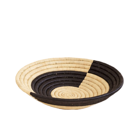 Woven basket with black and beige pattern on a white background
