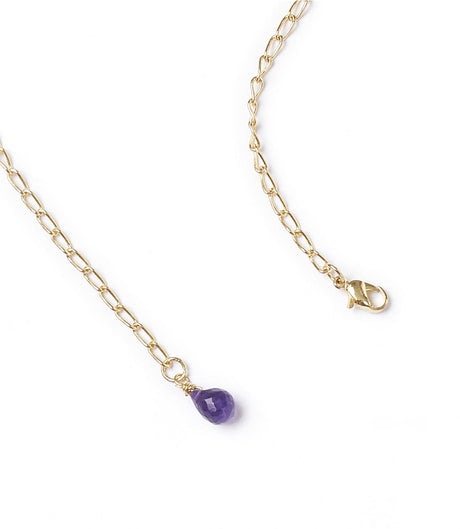 Gold necklace with a purple teardrop pendant on a white background