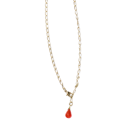 Gold necklace with a red teardrop pendant on a white background