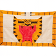 Decorative quilt with geometric pattern on a textured wall