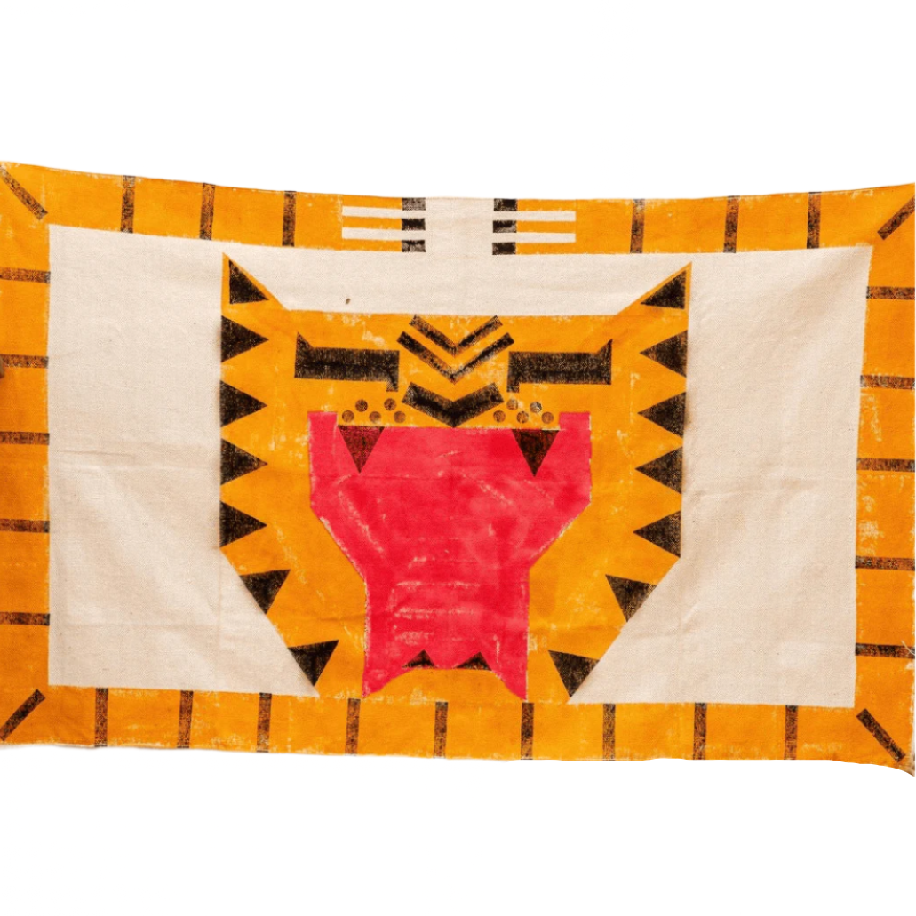 Decorative quilt with geometric pattern on a textured wall