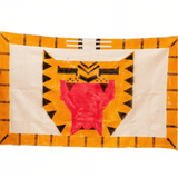 Decorative quilt with geometric pattern on a textured wall