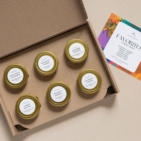 Set of small jars with gold lids in a cardboard box, with a card on the side. 2oz Mini Tins 6 Count