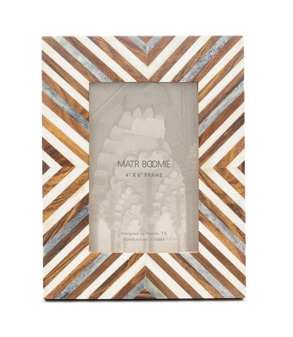 Wooden picture frame with geometric pattern on a white background