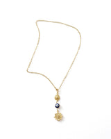 Gold necklace with decorative elements on a white background