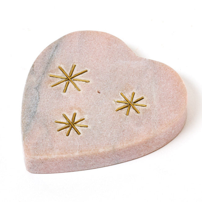 Heart-shaped stone with gold star designs on a white background