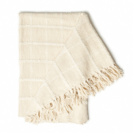 Beige woven blanket with fringes on a white background