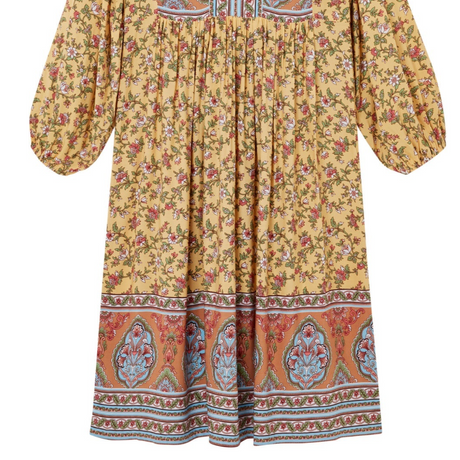 Yellow floral dress with patterned hem on a white background