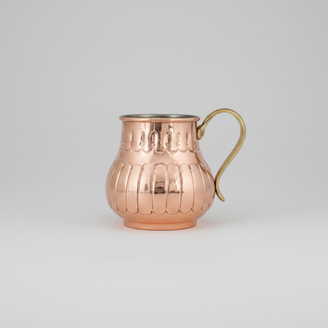 Copper pitcher with a handle on a white background