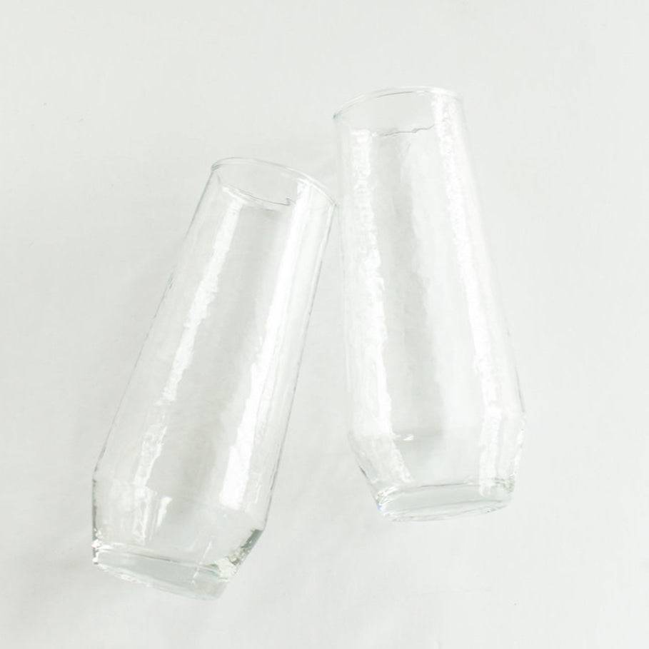 Two clear glass tumblers on a white background