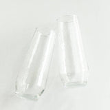 Two clear glass tumblers on a white background