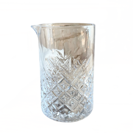 Clear glass pitcher with diamond pattern on a white background