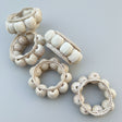 Set of decorative napkin rings with braided designs on a white background