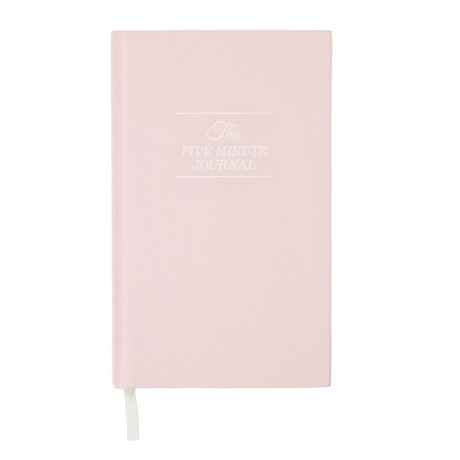 Pink journal with 'The Five Minute Journal' text on a white background