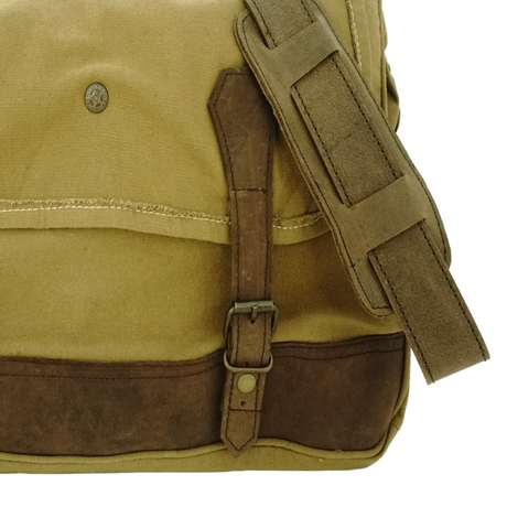 Brown leather bag with strap on a white background