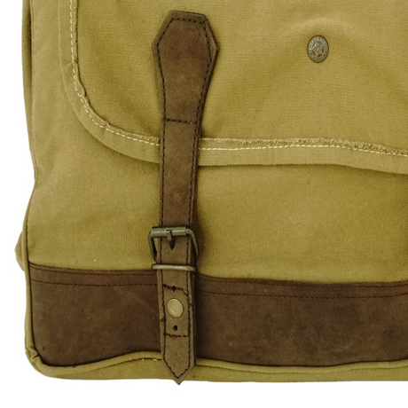 Close-up of a beige bag with brown leather strap and trim on a white background