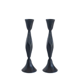 Two black twisted candle holders on a white background